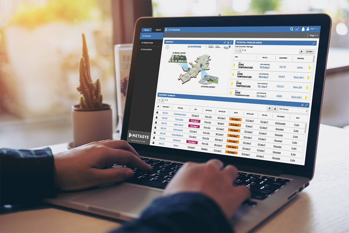 image showing hands typing on a laptop with the Metasys dashboard UI on the screen