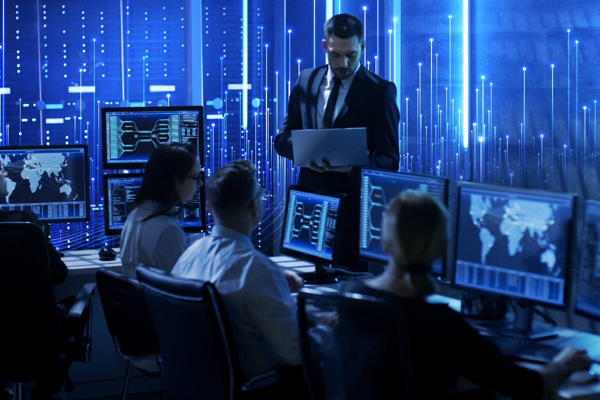 Employees monitor cyber security from their work stations.