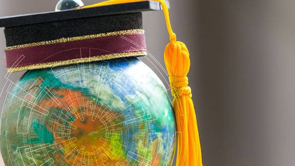 A graduation hat placed on top of a globe