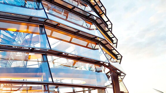 Close-up on a glass building against the sky