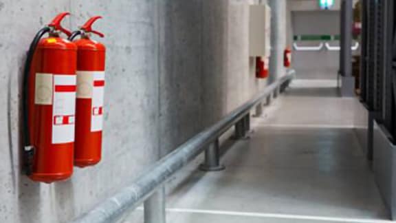 Fire extinguishers installed in a building corridor